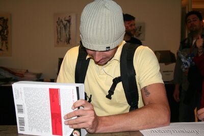 Charl signs a book.