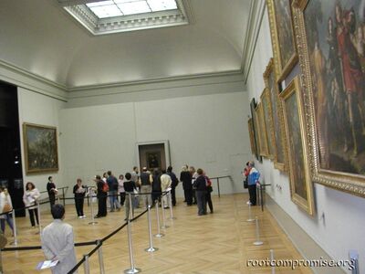 People looking at the Mona Lisa.