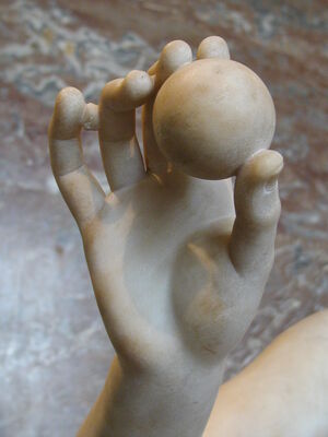 Hand holding a ball, Louvre, Paris.