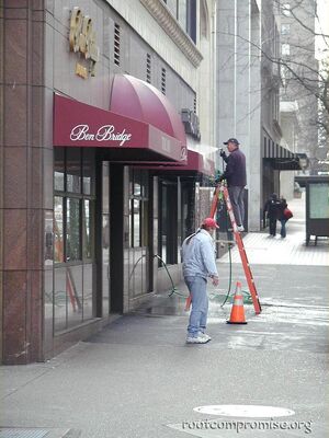 Some guy hosing down the awning of a store on Sunday morning, I just thought it looked kool.