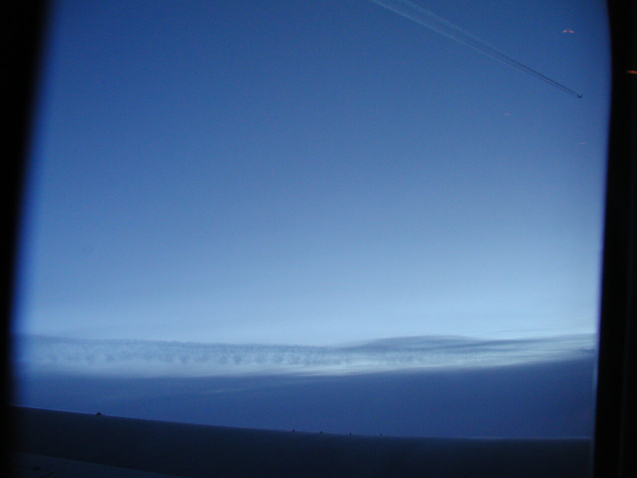 A plane flying close to my plane over the Atlantic Ocean.